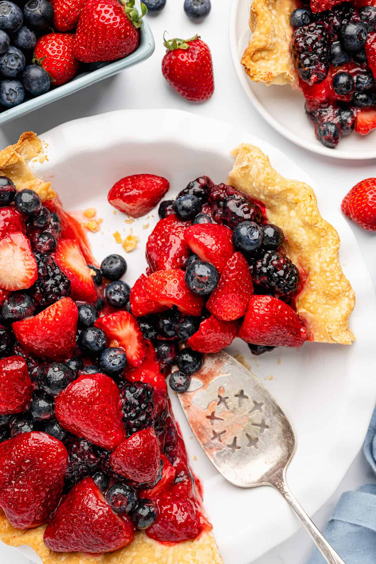 Berry Pie Mixed berry pie with strawberries, blueberries, and blackberries on a flaky crust.