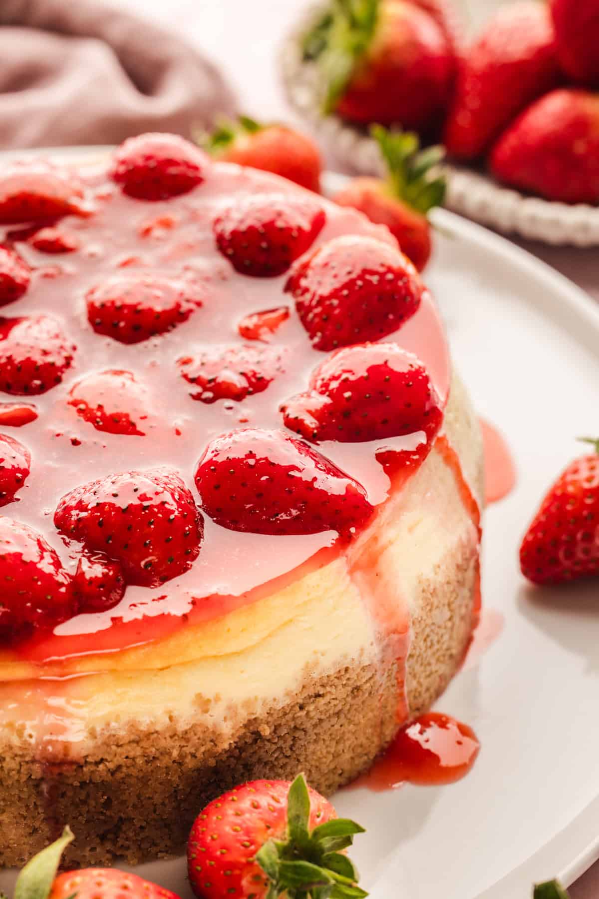 Classic New York-Style Cheesecake A cheesecake topped with whole strawberries and strawberry glaze.