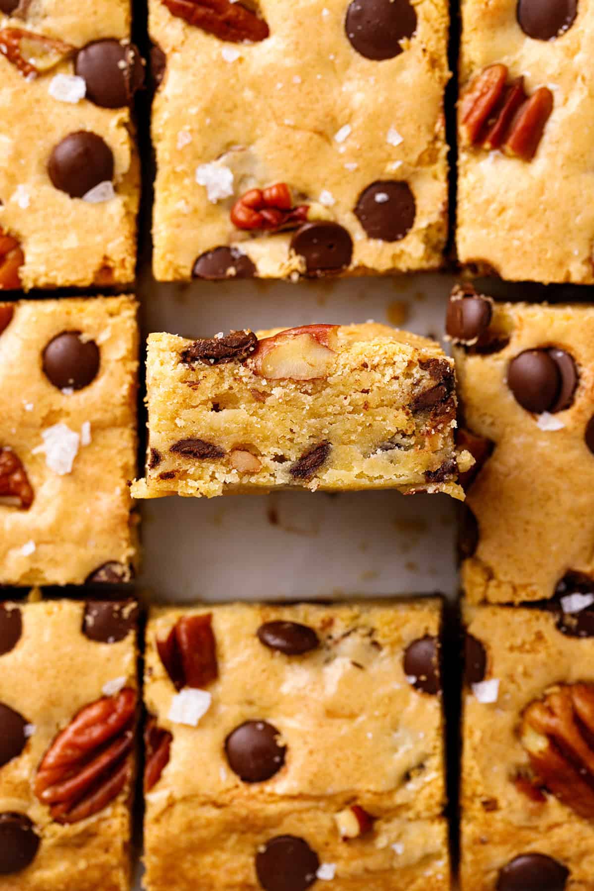 Blondies Nine golden-brown cookie bars with chocolate chips and pecans, arranged in a grid.