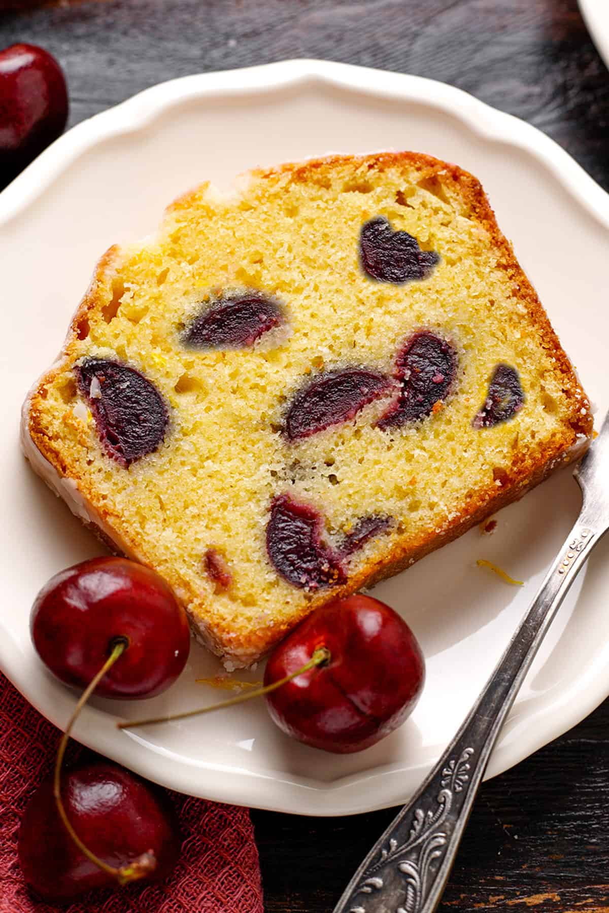 Cherry Loaf Cake A slice of cherry loaf cake on a white plate.