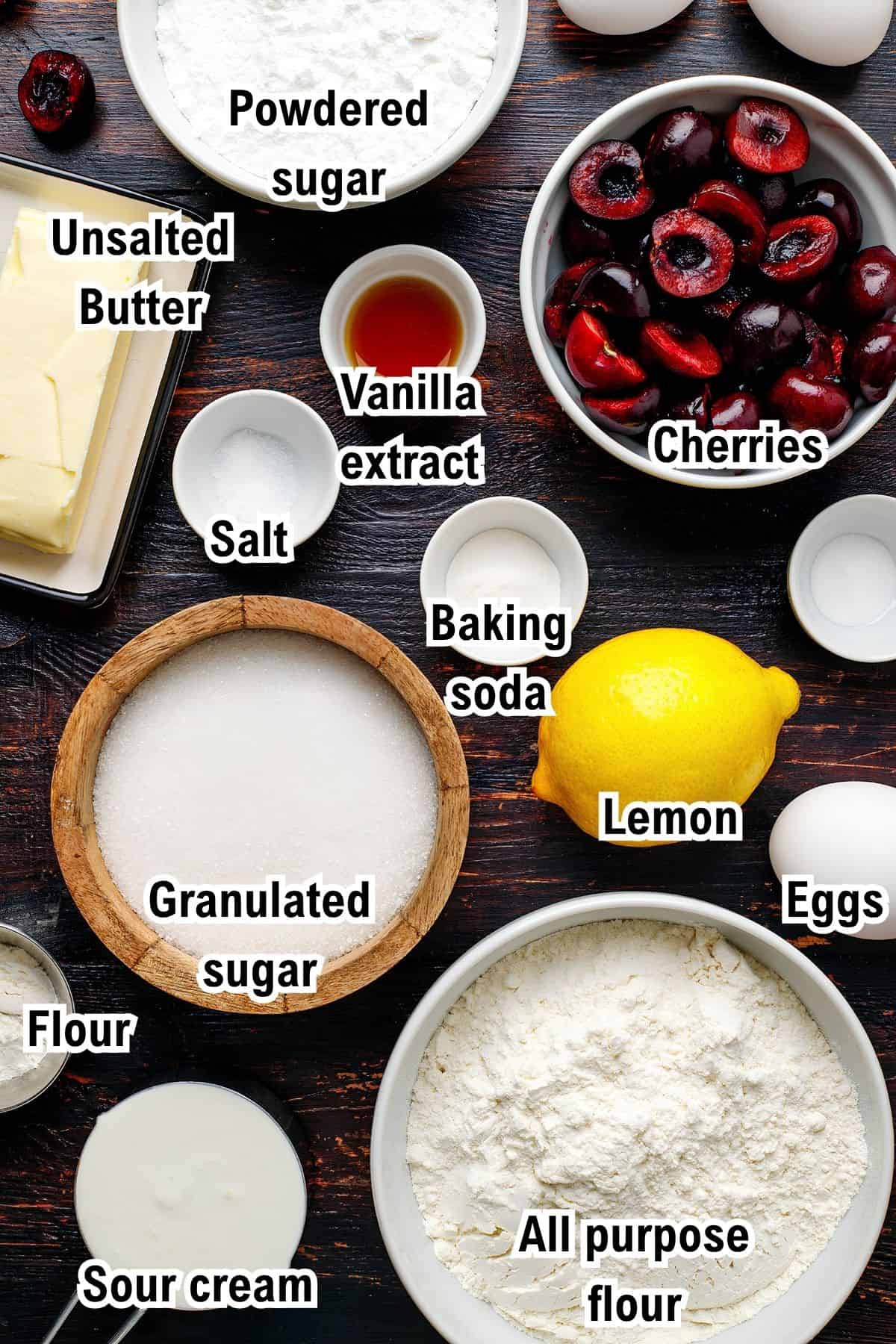 The Ingredients for Cherry Loaf Cake This photo shows the ingredients for Cherry Loaf Cake: including cherries, eggs, a lemon, sour cream, vanilla extract, sugars, flours, baking soda, salt, and unsalted butter.