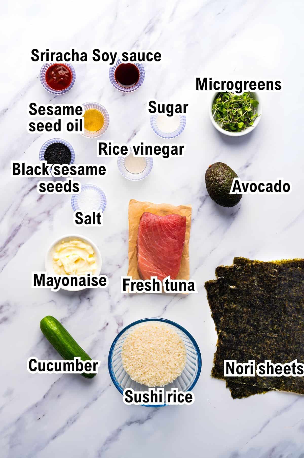 The Ingredients for Spicy Tuna Hand Rolls This photo shows the ingredients for Spicy Tuna Hand Rolls, including fresh tuna, sushi rice, nori sheets, cucumber, avocado, microgreens, mayonnaise, salt, black sesame seeds, rice vinegar, sugar, sesame seed oil, and Sriracha soy sauce.