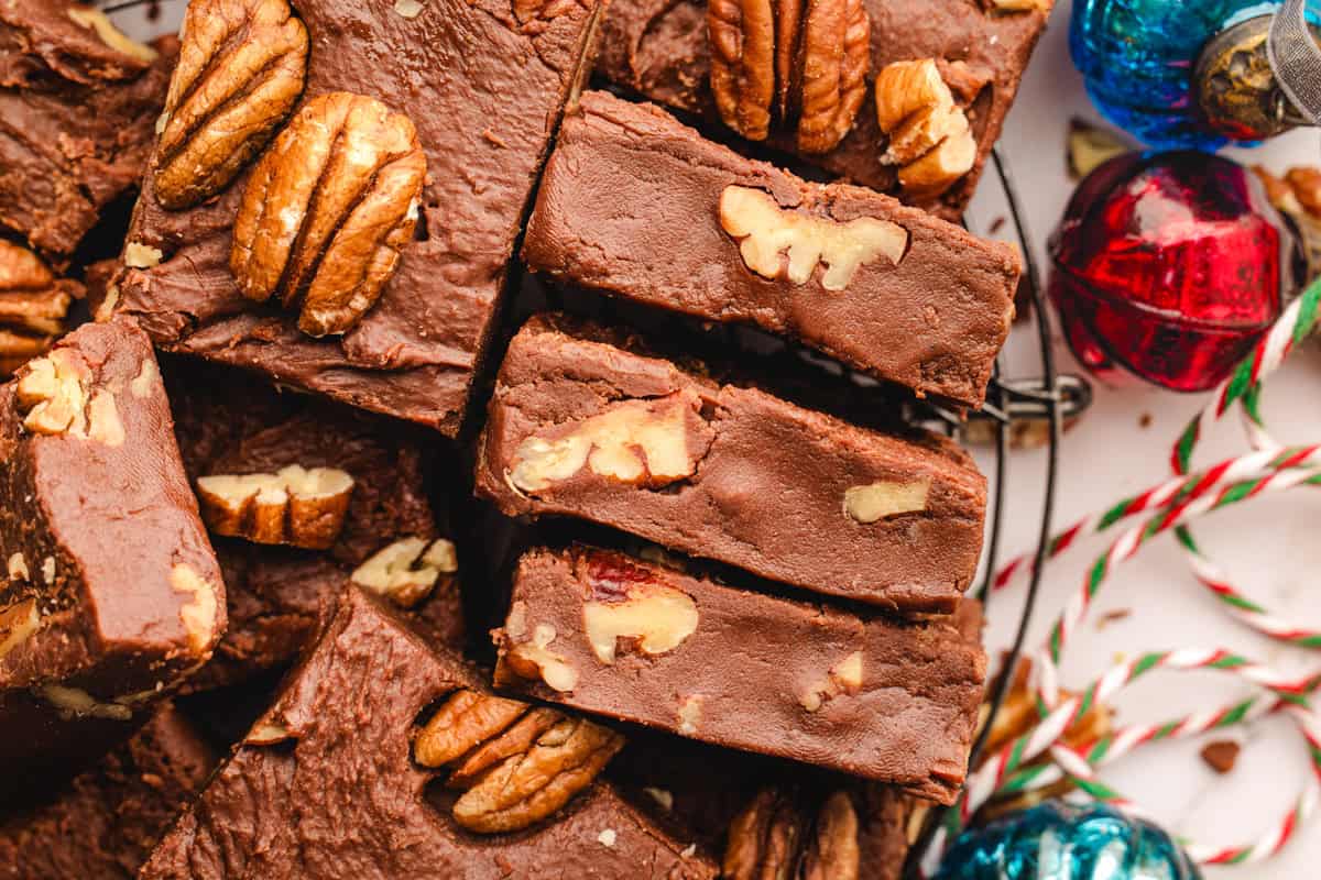 Fantasy Fudge Chocolate fudge bars with pecans, stacked together on a plate.