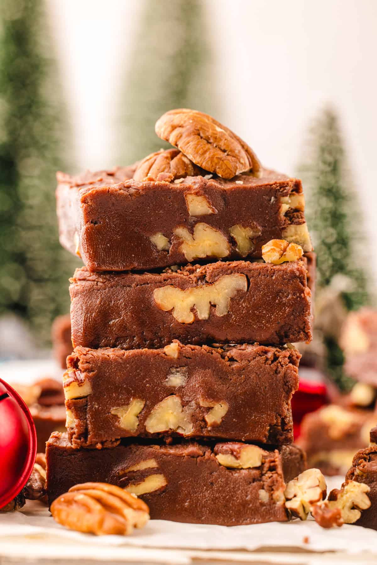 Fantasy Fudge Four thick slices of chocolate pecan fudge are stacked, with whole pecans both in and on top of the fudge.