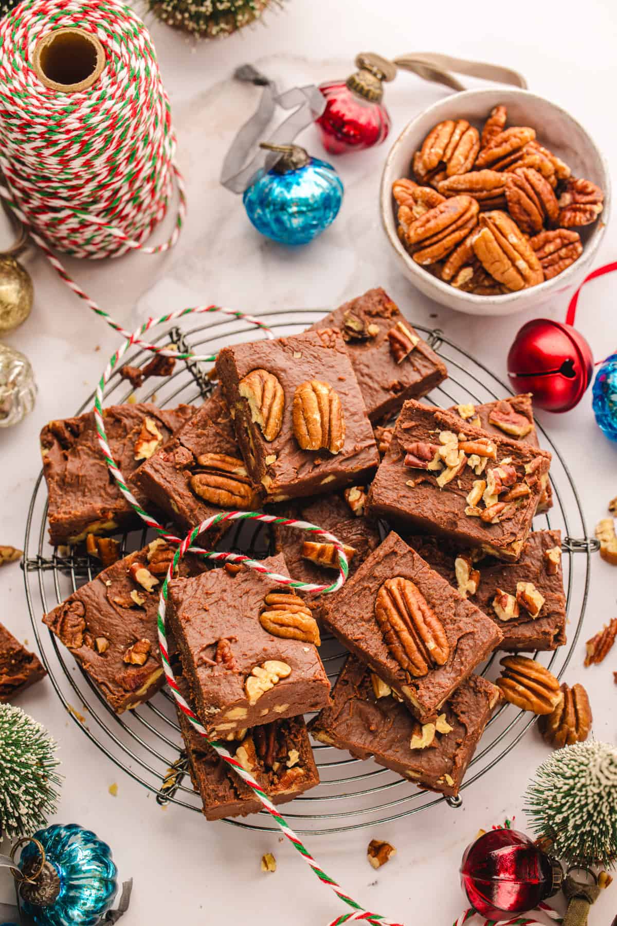 Fantasy Fudge A pile of chocolate fudge topped with pecans sits on a cooling rack.