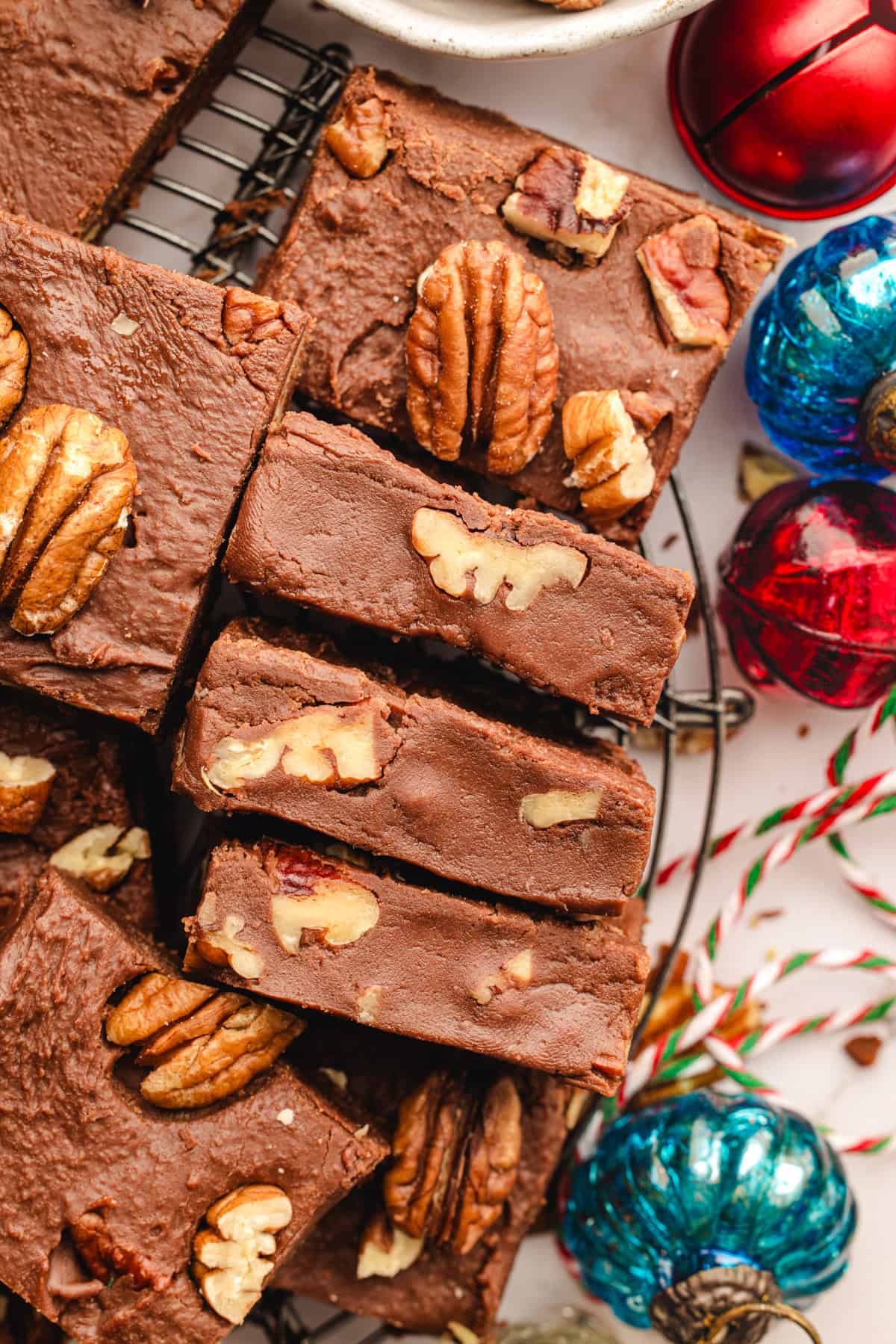 Fantasy Fudge Slices of chocolate fudge with pecans on top, arranged on a wire rack.