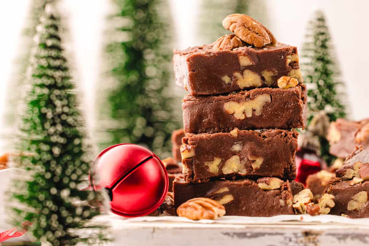 Fantasy Fudge A stack of chocolate fudge squares is shown with pecans on top.