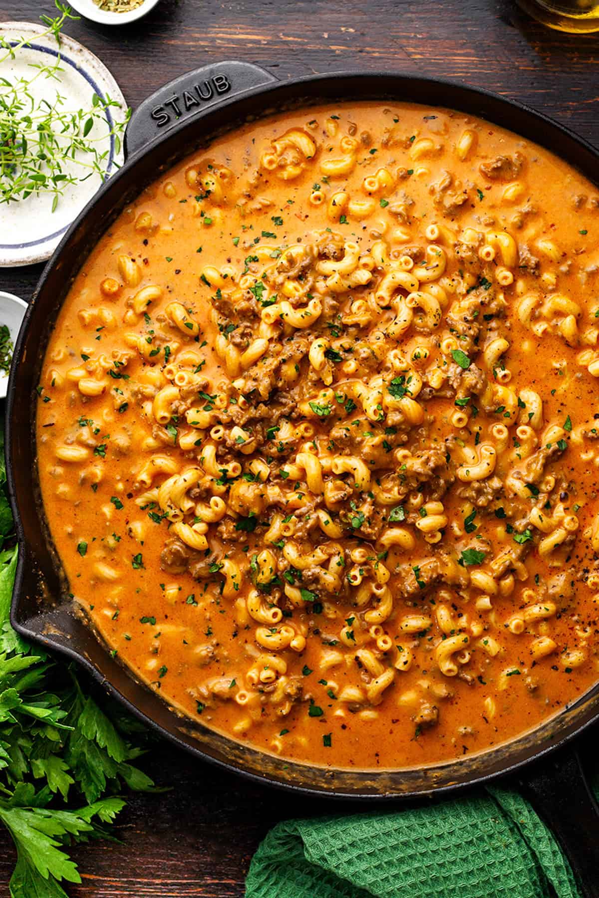Hamburger Helper A skillet filled with creamy beef and macaroni pasta, garnished with chopped parsley.