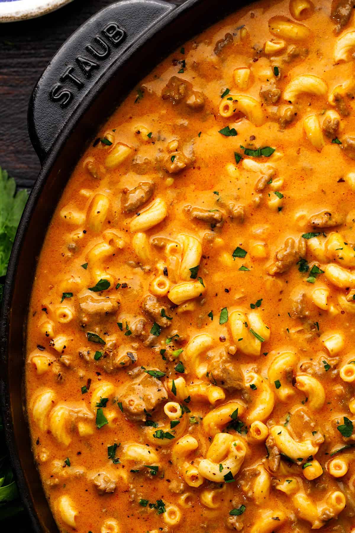 Hamburger Helper A close-up of creamy beef macaroni in a pot, garnished with chopped herbs.