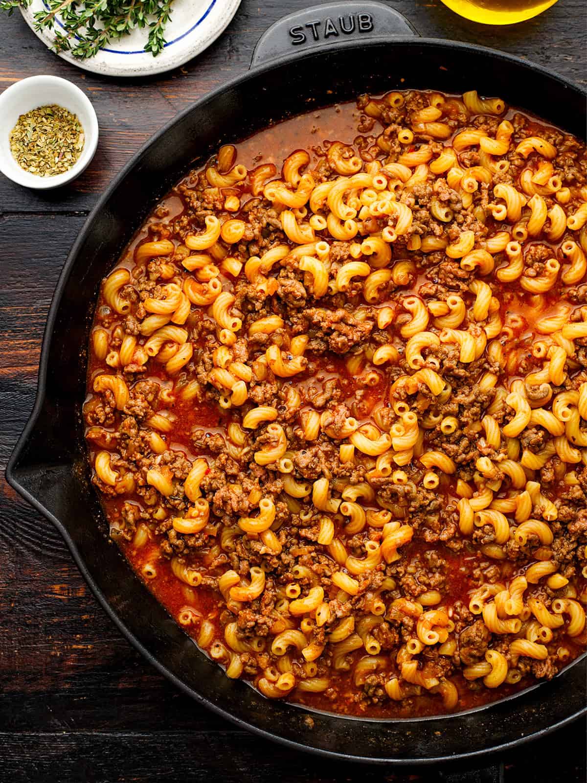 Hamburger Helper A skillet filled with cooked elbow macaroni, ground beef, and tomato sauce.