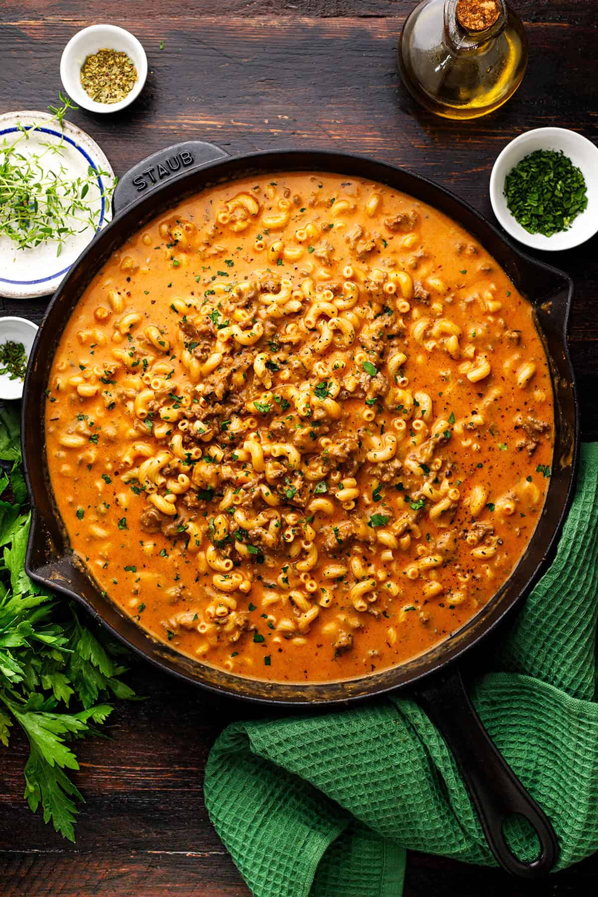 Hamburger Helper A skillet filled with creamy macaroni and ground meat sauce, garnished with chopped herbs.