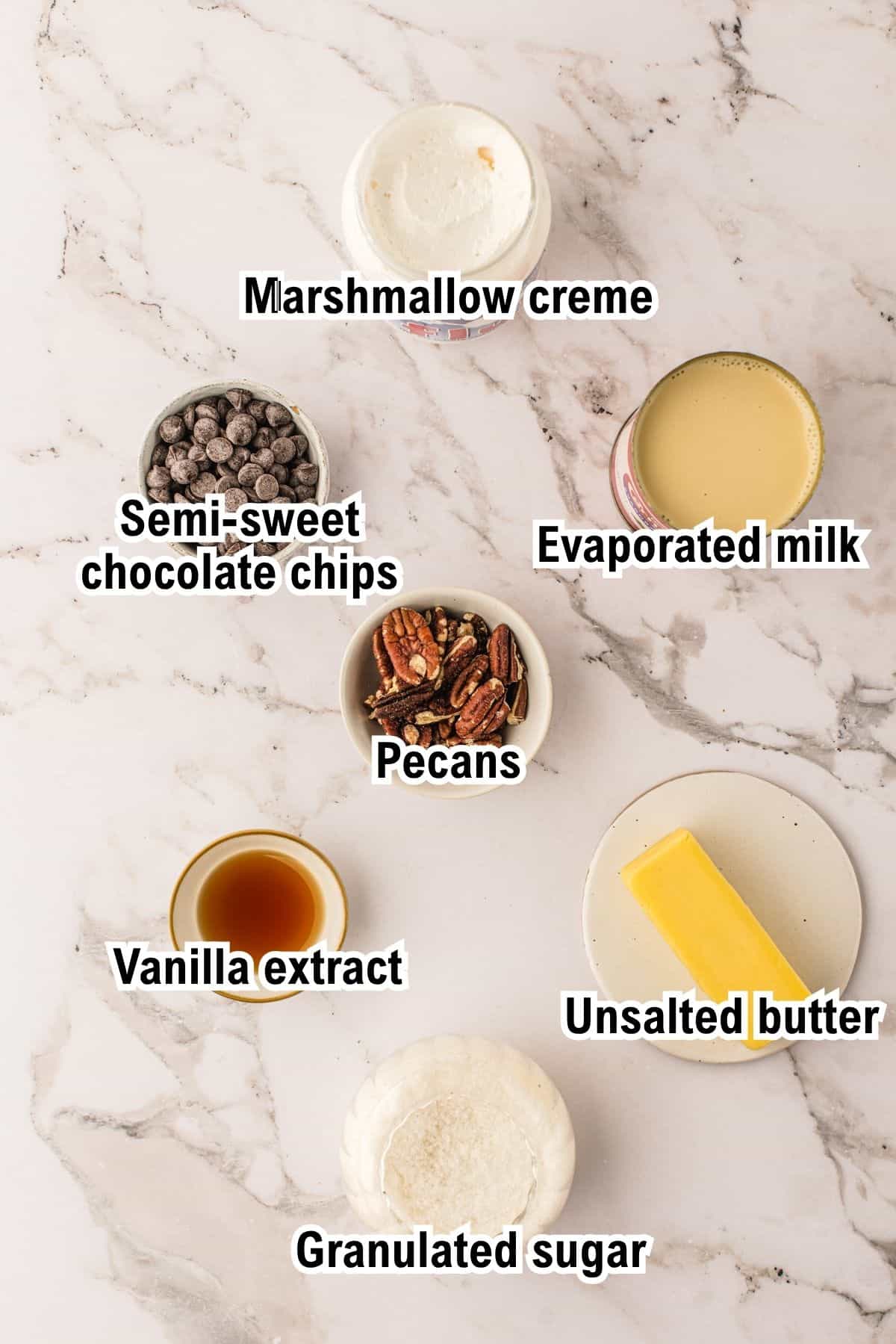 The Ingredients for Fantasy Fudge This photo shows the ingredients for Fantasy Fudge: marshmallow creme, semi-sweet chocolate chips, evaporated milk, pecans, vanilla extract, unsalted butter, and granulated sugar.