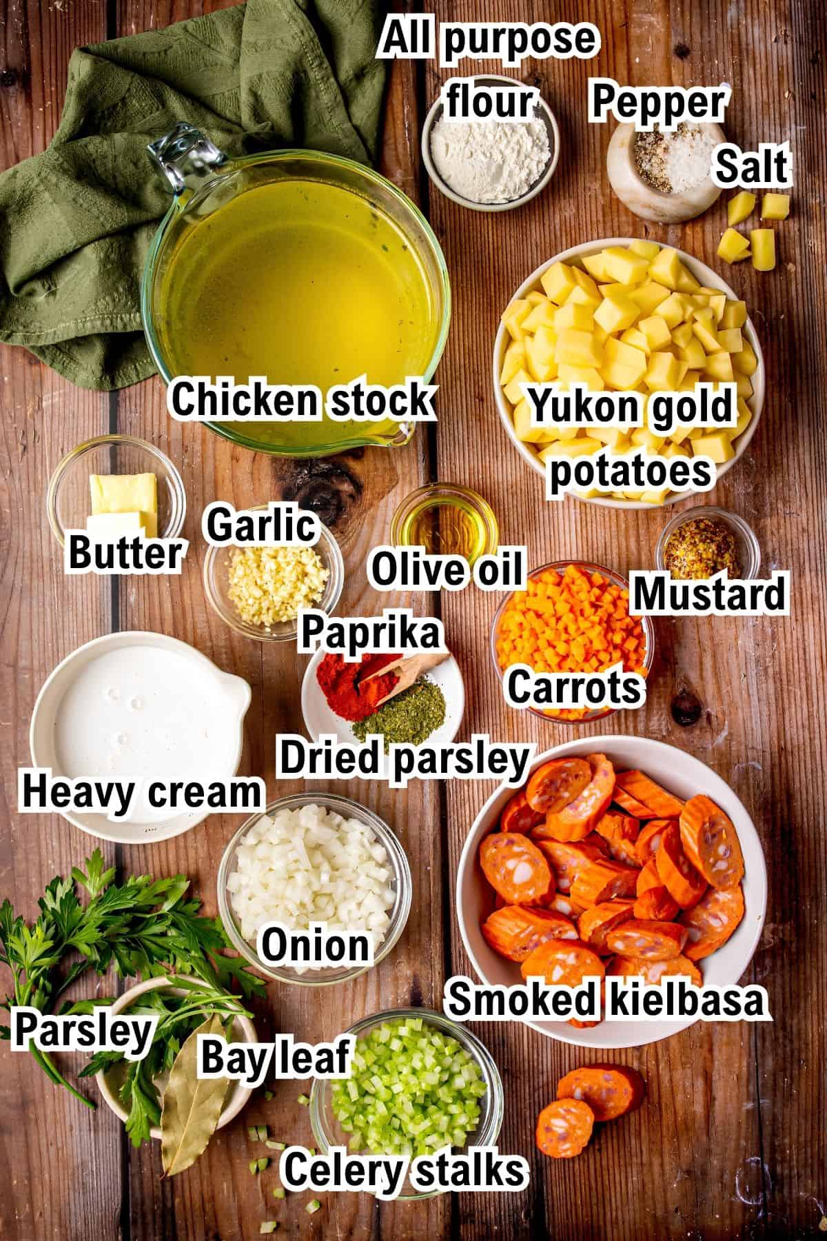 The Ingredients for Kielbasa Potato Soup This photo shows the ingredients for Kielbasa Potato Soup: including chicken stock, potatoes, carrots, smoked kielbasa, onion, celery, bay leaf, parsley, cream, butter, flour, garlic, olive oil, paprika, dried parsley, mustard, salt, and pepper.