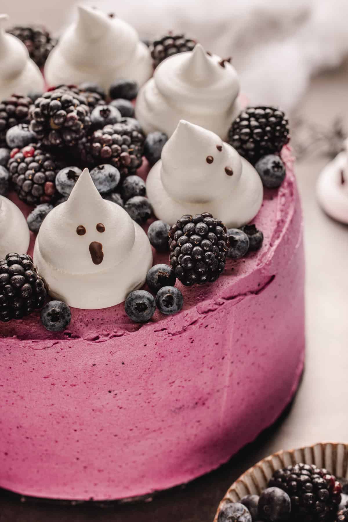 Halloween Cake A bright pink berry cake topped with fresh blackberries, blueberries, and meringue ghosts.