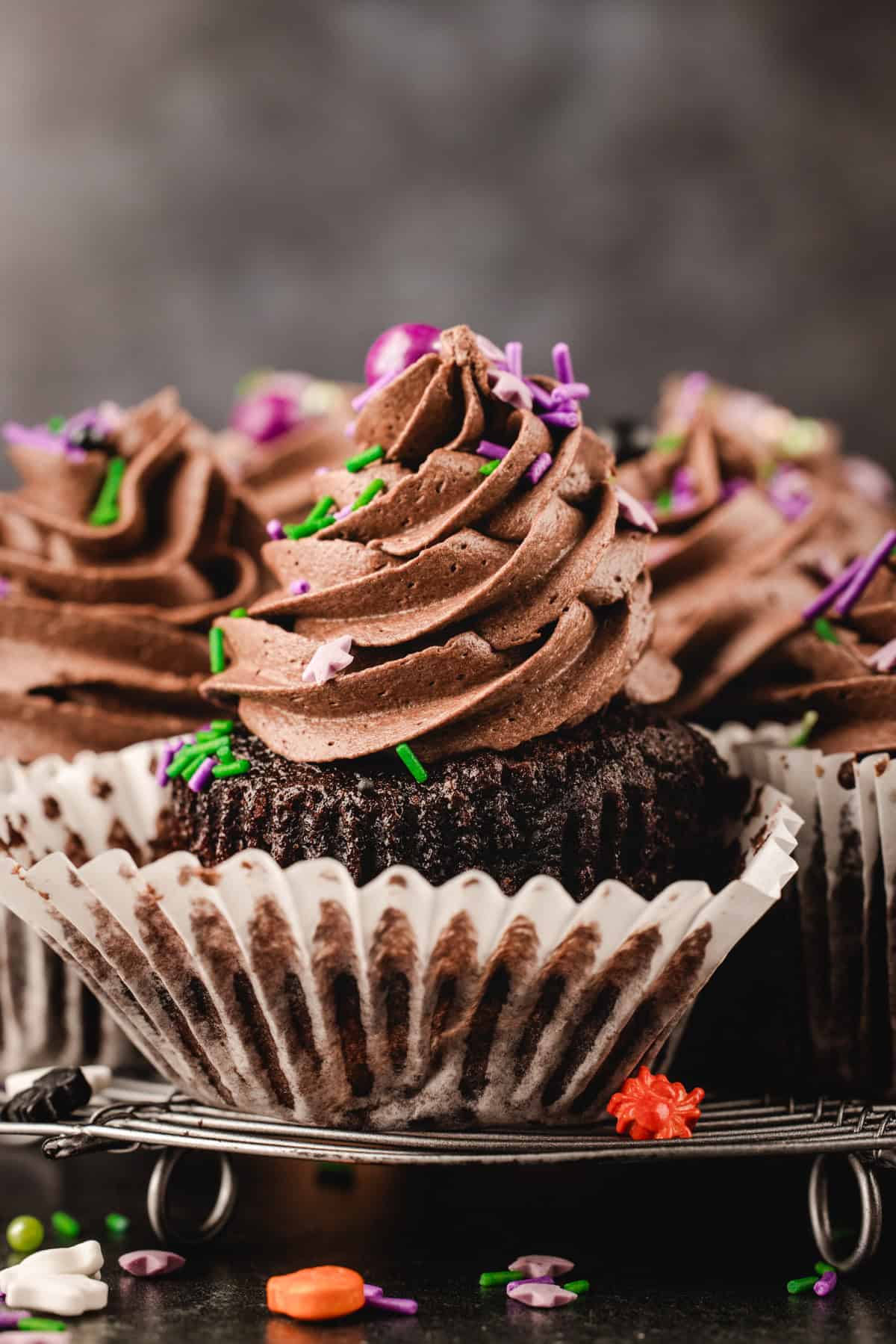 Halloween Cupcakes Chocolate cupcakes with swirled frosting and colorful star and sprinkle toppings in white paper liners.