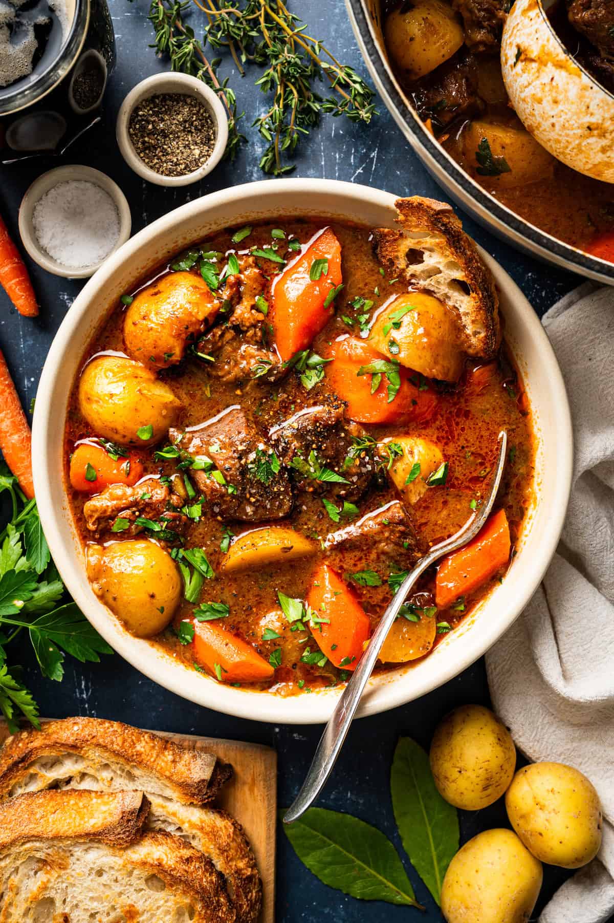 Irish Beef Stew A bowl of beef stew with potatoes and carrots, garnished with fresh herbs.